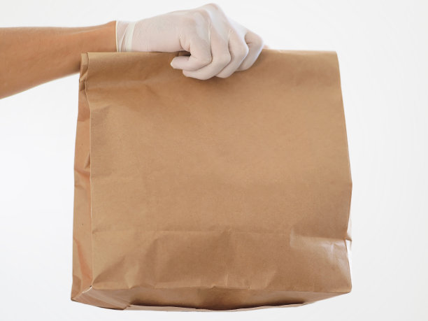 特写镜头。冠状病毒期间的安全食品配送。副本的空间。图片下载