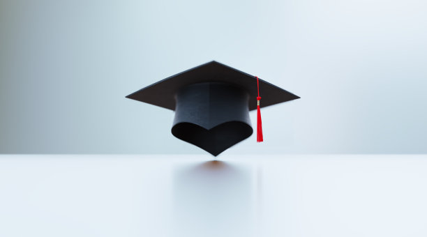 毕业帽坐在白色表面前散焦背景图片下载