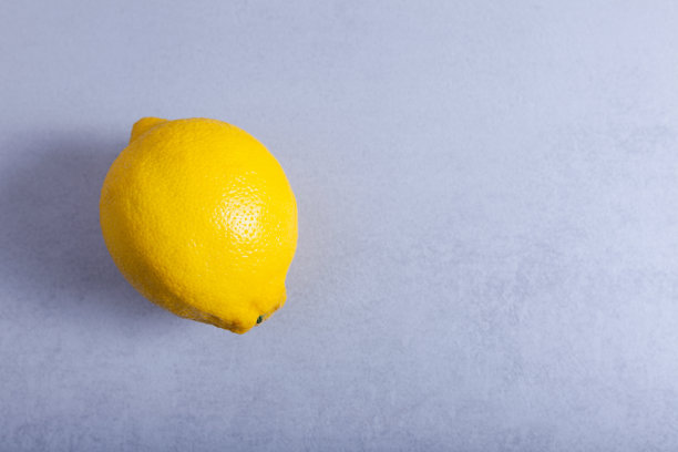 一个新鲜的柠檬和一个中性的背景图片下载