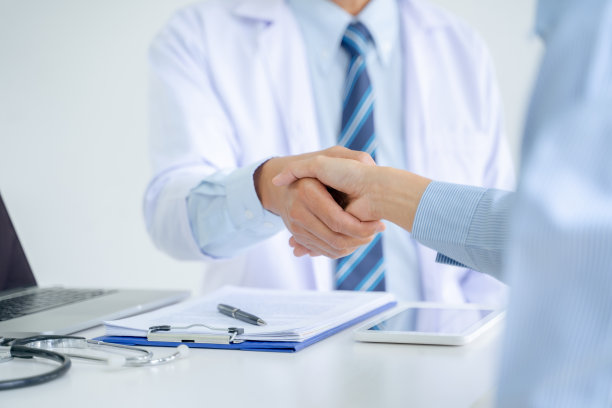 医生在医院里与病人握手。图片下载