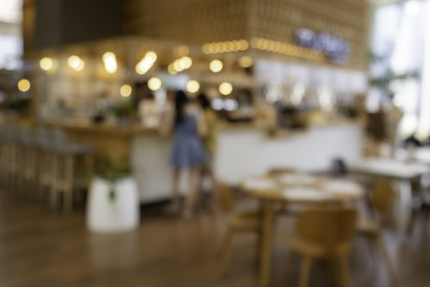 模糊城市里的餐厅和咖啡馆的暖色调背景图片下载