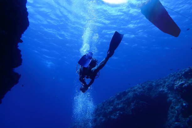 潜水员，船和太阳在水下游泳图片下载
