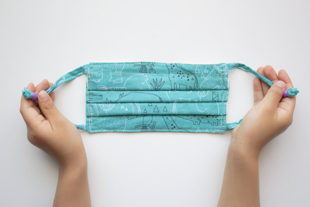 一个拿着白色背景的彩色面具的孩子图片下载