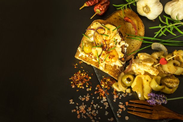 用橄榄油和香料腌制的卡芒贝尔干酪。自制的腌奶酪配辣椒。腌奶酪配香草，橄榄。图片下载