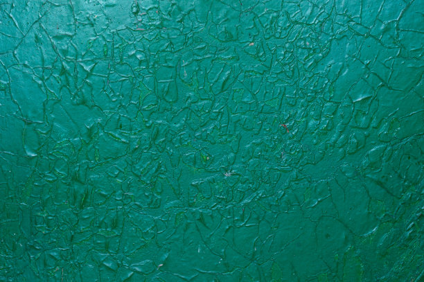 绿色金属生锈的。这生锈的金属的纹理是绿色的。旧金属表面上龟裂、脱落的油漆。图片下载