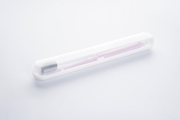 白色背景下，白色牙刷盒内，粉色牙刷，黑色保护罩，孤立。图片下载