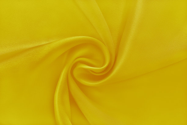 面料金黄金黄，布料质地为背景和设计艺术作品，美丽的褶皱图案的丝绸或亚麻。图片下载