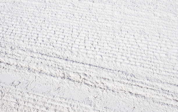 沙滩上的白色沙滩，有轮子图案的纹理。沙子上有自行车轮胎的痕迹。热带海滩照片背景图片下载