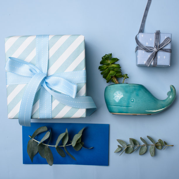 两个蓝色的礼品盒，一个蓝色的礼品信封和一个鲸鱼形的花瓶图片下载