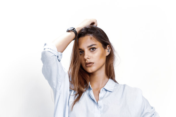 美丽的黑发女模特在孤立的背景下在工作室摆姿势。图片下载