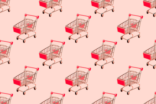 购物车无缝模式上柔和的粉红色背景。图片下载