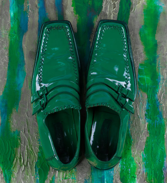 男人绿色的鞋孤立在绿色的背景图片下载