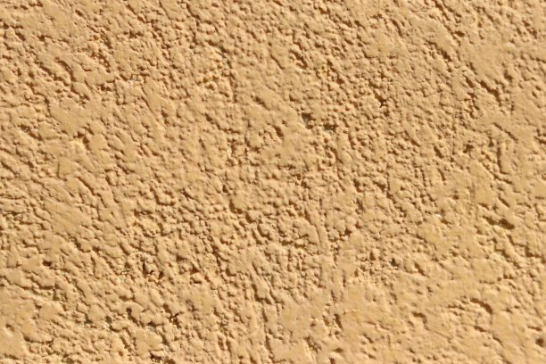 装饰墙用漂亮的石头砌成黄色的水泥墙。图片下载