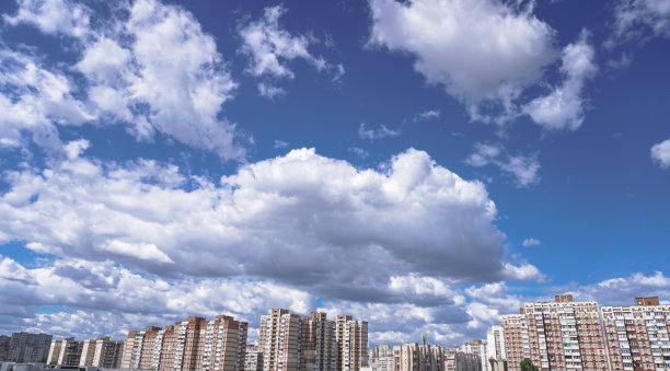 公寓大楼在美丽的云彩的背景下。高层建筑是用人们居住的面板结构建造的。库存图片背景图片下载