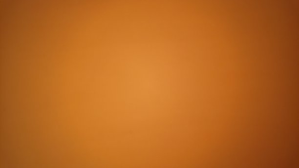 纸是橙色的。非均匀照明。在纸的中间色调较浅，在边缘处有暗晕。质地,背景,明信片。温暖的柑橘调图片下载