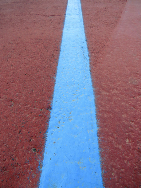 红色的地板背景和蓝色的线条。信号和灯塔。城市沥青的图案和纹理。图片下载