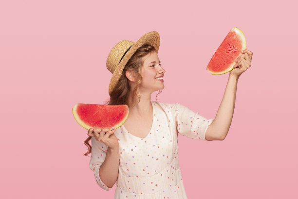 快乐的女性在西瓜片之间选择图片下载