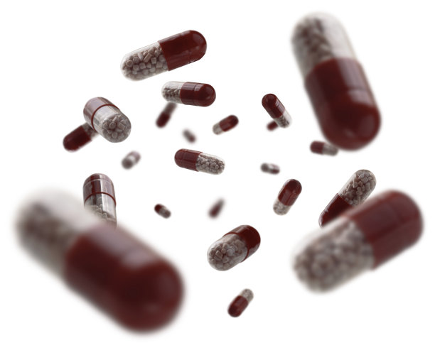 带有药物的胶囊漂浮在白色的背景上图片下载
