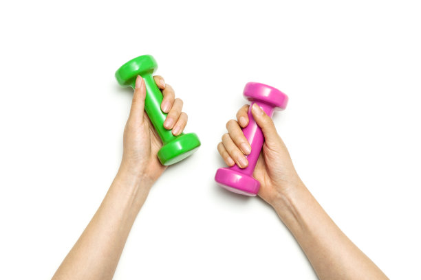 女人双手举着两个哑铃在白色背景上。图片下载
