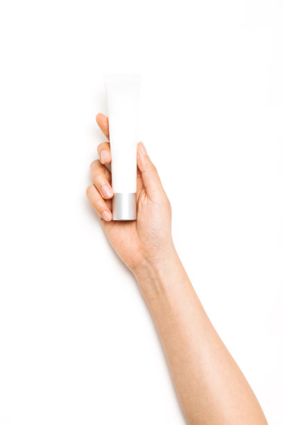 女人手里拿着一个化妆品容器，管上白底。图片下载