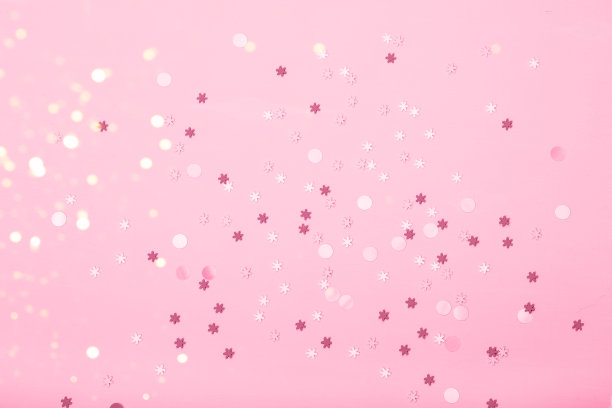 粉红色的背景上点缀着小雪花图片下载