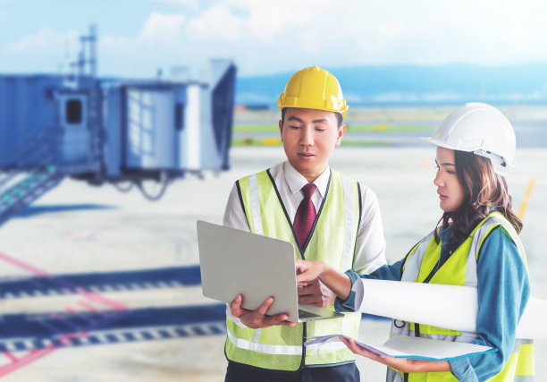 两名航空机场工程师男女正在讨论文件工厂。图片下载