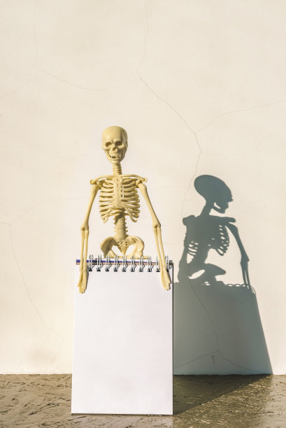 表格上的骨架和笔记纸，文本复制空间，万圣节模板。图片下载