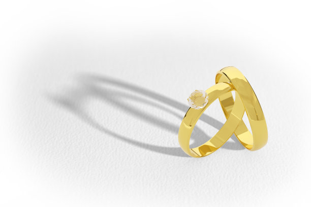 一对黄金和钻石结婚戒指孤立在白色的背景。3 d演示。图片下载