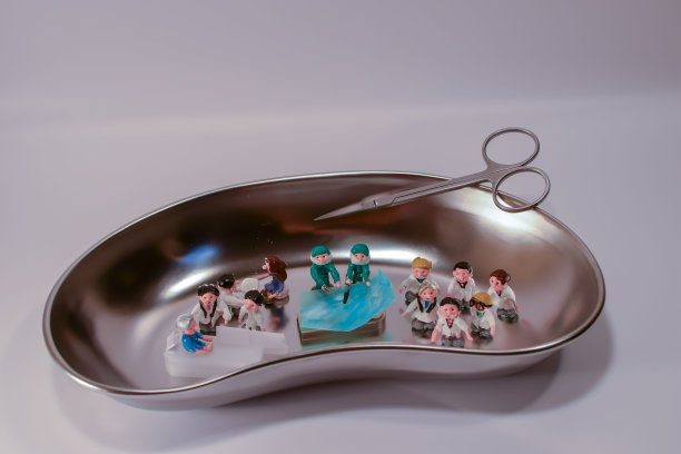 在脓盘上工作的医生的微型娃娃。图片下载