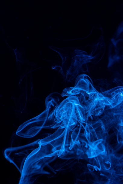 概念形象的蓝色烟雾孤立在黑色的背景，万圣节的设计元素概念。图片下载