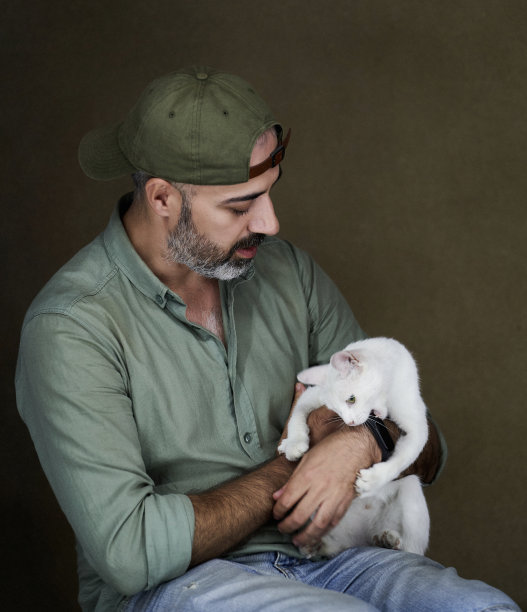 男人和他的白猫，室内肖像。图片下载