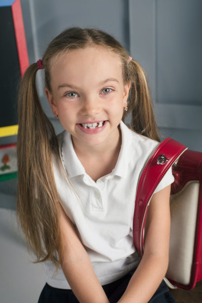 快乐的小学生在教室里背着大大的书包图片下载