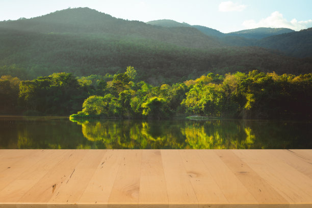木制的桌面与热带森林和湖泊的背景春季设计图片下载