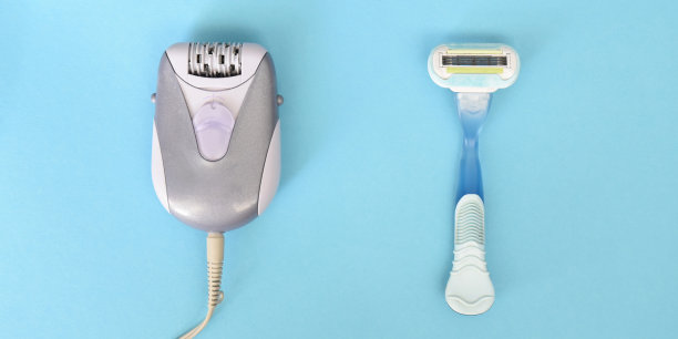 脱毛对剃刀在蓝色的背景。去除毛发的脱毛方法图片下载