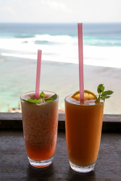 两杯以印度洋为背景的水果鸡尾酒吸管图片下载