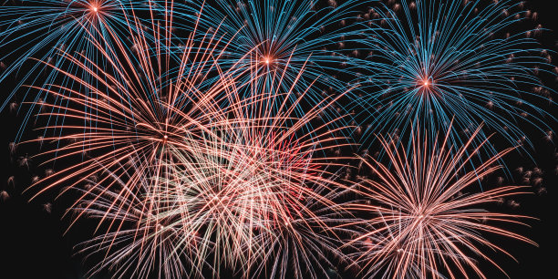 真正五颜六色的烟花在夜空中，五颜六色的烟花在黑色的背景上图片下载