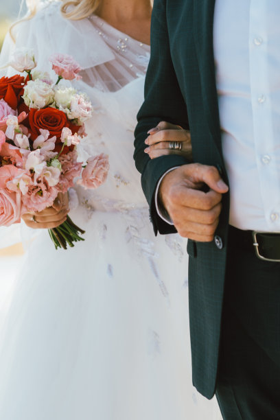 婚礼当天新郎和新娘手牵手的特写家庭爱的概念图片下载