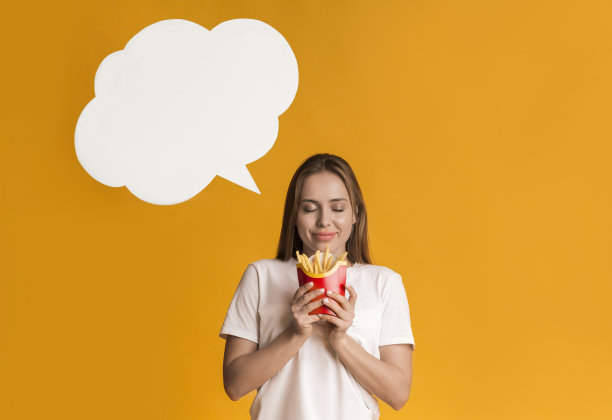 年轻女子拿着薯条，梦想着什么图片下载