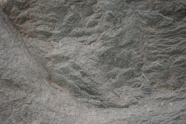 灰棕色的石头背景。岩石纹理。花岗岩山体表面纹理。宏。图片下载