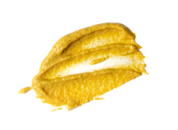 芥末酱飞溅隔离，涂抹第戎蜂蜜奶油图片下载