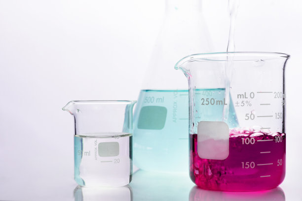 在白色的科学实验背景下，在烧杯中倒入粉红色的化学溶液图片下载
