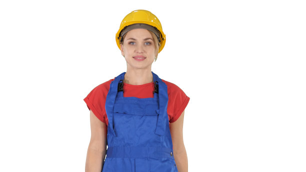 穿着黄色安全帽的年轻女子走在白色的背景上图片下载