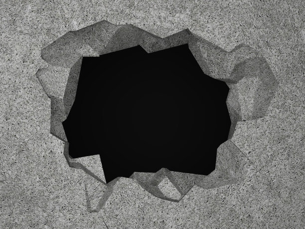 混凝土墙上的一个洞。图片下载