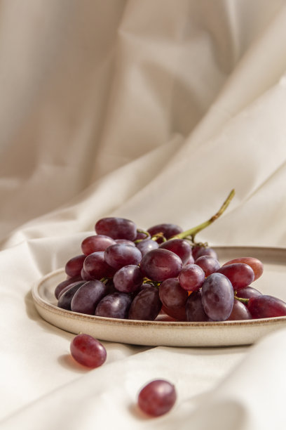 鲜嫩多汁的紫色勃艮第葡萄在明亮的背景上图片下载