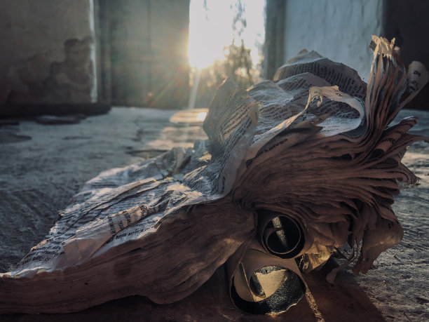 一本旧的、破旧的、不必要的、破损的、歪歪斜斜的书躺在肮脏的、黑暗的泥土地板上图片下载