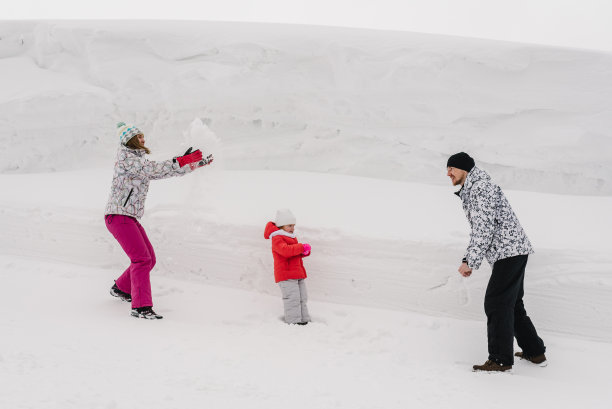 妈妈，爸爸和宝宝，女儿在雪地里散步和扔雪。圣诞节周末假期。在山顶上过寒假。快乐的一家人在冬日里玩耍。图片下载