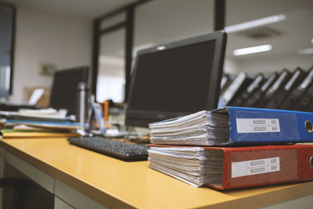 办公室办公桌上的特写文件文件，以软焦点和过光为背景图片下载