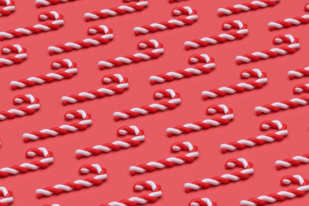 明亮的粉红色抽象背景与圣诞糖果手杖排列在一排图片下载