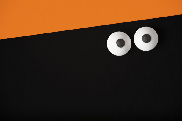 万圣节背景，一双眼睛上的黑色和橙色，复制空间。图片下载