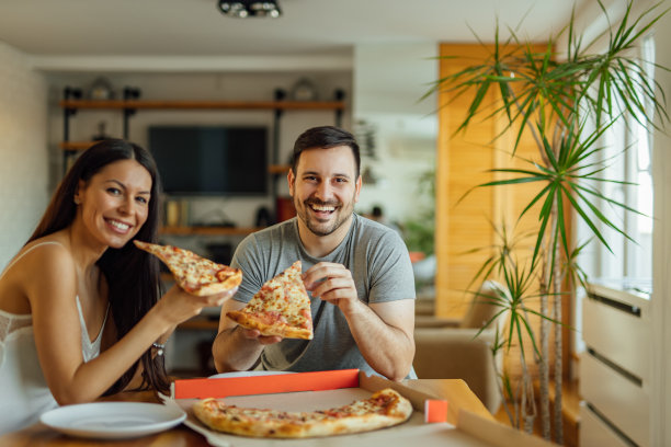 一对夫妇早餐吃披萨，肖像。图片下载
